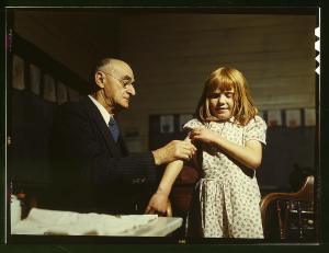 Dr. Schreiber of San Augustine giving a typhoid innoculation at a rural school, San Augustine County, Texas 1943